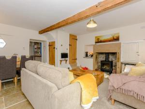 a living room with two couches and a fireplace at Whibberley Cottage in Ashford