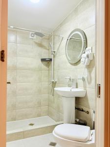 a bathroom with a toilet and a sink and a mirror at Four Rooms in Lagodekhi +41 photos