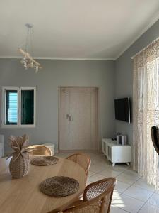 a dining room with a wooden table and chairs at Mare e Ricordi - Villa in Bari