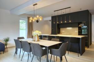 a kitchen with a dining room table and chairs at Villa One in Jastrebarsko