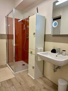 a bathroom with a sink and a shower at Ales apartment in Cuneo +17 photos