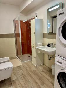 a bathroom with a shower and a toilet and a sink at Ales apartment in Cuneo