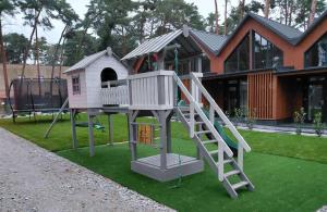 a playground with a slide and a play house at Dominickie Antresole in Boszkowo-Letnisko