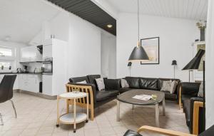 a living room with a couch and a table at Stunning Home In Blokhus With Sauna in Blokhus