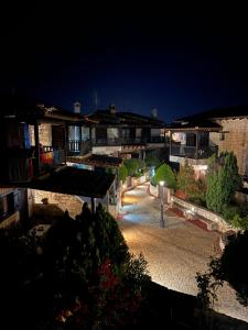 a view of a courtyard at night with buildings at Afytos house in Afitos