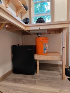 a kitchen under a sink with an orange bucket under it at Highway HotTub Hideaway Bunkbed sleeps two in Tok