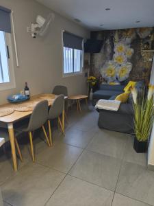 ein Wohnzimmer mit Tisch und Couch in der Unterkunft Center Flat Puerto Del Carmen near the Beach NATURAL ELEMENTS APARTMENT in Puerto del Carmen