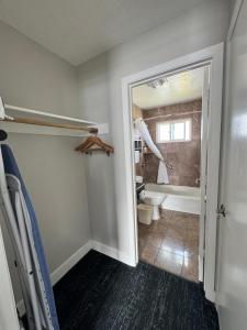 a bathroom with a toilet and a bath tub at Stargazer Inn and Suites in Monterey +29 photos