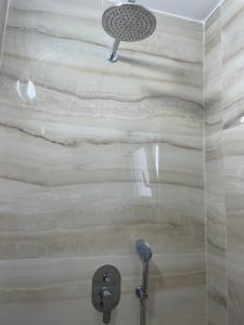 a shower with a shower head in a bathroom at Apartment Katerina in Himare