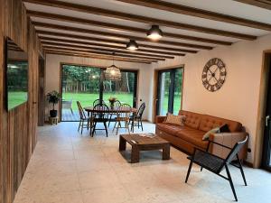 a living room with a couch and a table at Bernātu Kalnmaļi in Bernāti