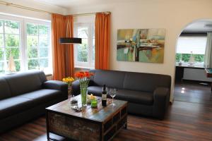 Una sala de estar con dos sofás y una mesa. en Ferienhaus Nadja, en Westerland