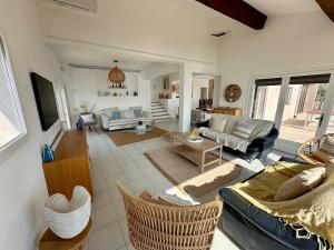 a living room with a couch and a table at Villa Naïma Esterel in Saint-Raphaël