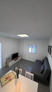 a living room with a couch and a table at A Casiña do Castiñeiro, Melide in Melide +10 photos