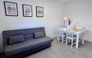 a living room with a couch and a table and chairs at A Casiña do Castiñeiro, Melide in Melide