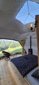 a bedroom in a tent with a bed in it at GLAMPING Považie in Trenčín