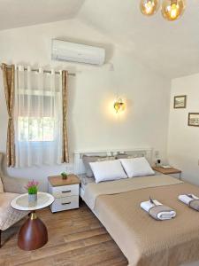 a bedroom with two beds and a table at Sunny Side Apartments in Rijeka Crnojevića