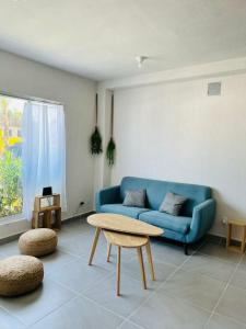 a living room with a blue couch and a table at Puerta al Sol in Acapulco
