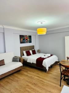 a bedroom with a large bed and a couch at Taksim Rain Suite in Istanbul