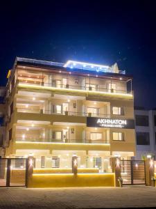 a large building with a sign on it at night at AKHNATON Pyramids View Hotel With Rooftop Access & free airport pickup in Cairo +192 photos