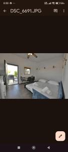 a picture of a bedroom with a bed and a table at kleris apartment 11 in Tinos Town