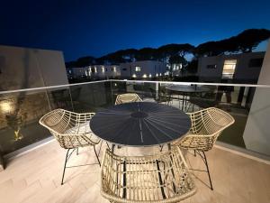 a table and chairs on a balcony with an umbrella at BelVilla in Lalzit Bay