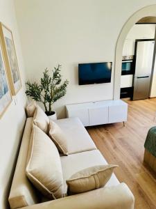 a living room with a couch and a tv at Holiday Home Lezha 2 in Lezhë