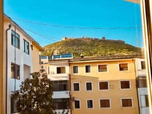 a view of a building with a hill in the background at Holiday Home Lezha 2 in Lezhë