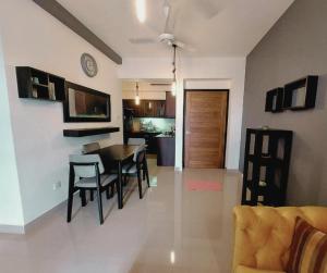 a dining room and living room with a table and chairs at Linaya in Colombo