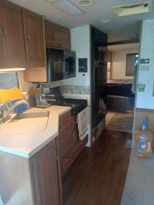 a kitchen with a sink and a stove top oven at Motorhome Casa rodante in San Mateo Río Hondo