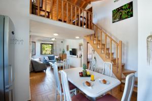 a dining room and living room with a white table and chairs at Rena's house in Zenempisátika