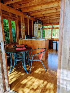 a dining room with a table in a cabin at RAIATEA - The BEACH HOUSE - plage sur le lagon ! in Tevaitoa