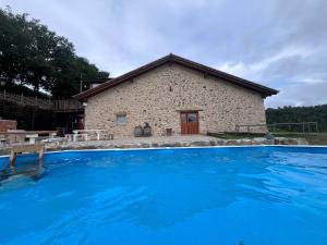 a large swimming pool in front of a building at Olabe hostel in Ea