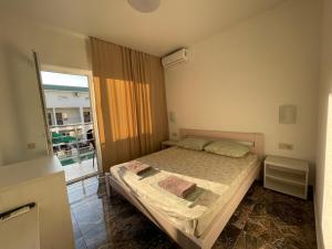 a small bedroom with a bed and a window at OSTRIV Hotel in Zatoka +58 photos