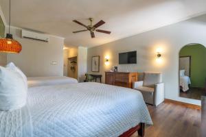 A bed or beds in a room at Travellers Beach Resort