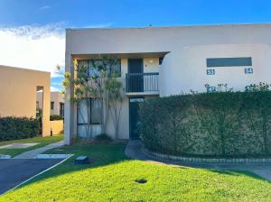 ein großes weißes Gebäude mit einem Hof davor in der Unterkunft Riverview Holiday Apartment 53 - Kalbarri, WA in Kalbarri + 7 Fotos