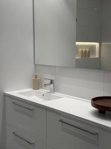 a white bathroom with a sink and a mirror at Casa Cimili City in Kristiansand +28 photos