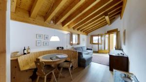 a living room with a table and a couch at Carla 12 in Sils Maria