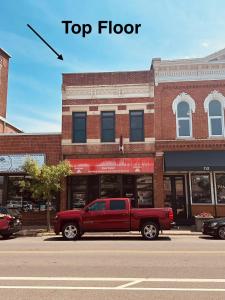 a red truck parked in front of a building at Gorgeous apartment across from La Crosse Center in La Crosse
