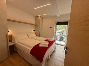 a bedroom with a large bed with a window at Al Piz - Dimora Alpina in Pellizzano