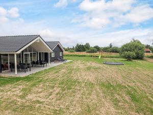 a house with a large yard in front of it at 5 star holiday home in Idestrup in Marielyst
