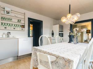 a kitchen and dining room with a table and chairs at 5 person holiday home in Snedsted in Snedsted
