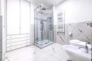 a white bathroom with a shower and a sink at Navona Boutique House in Rome +15 photos