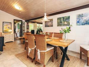 a dining room with a wooden table and chairs at 2 person holiday home in Grenaa in Grenå +22 photos