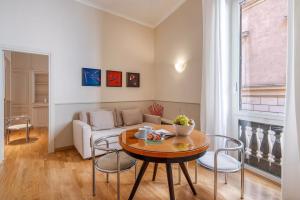 a living room with a table and a couch at Navona Boutique House in Rome