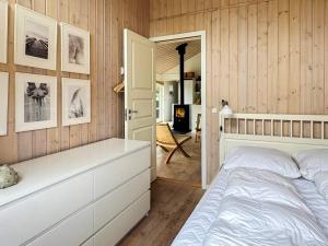 a bedroom with a bed and a hallway with a fireplace at 6 person holiday home in Øster Assels-By Traum in Sillerslev