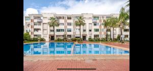 a large apartment building with a large swimming pool at Beach palace 1 between sea pool and city center in Mohammedia