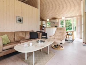 een woonkamer met een bank en een tafel bij 6 person holiday home in Løgstør in Løgsted +30 foto's