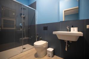 a bathroom with a toilet and a sink and a shower at Bivio 281 suite&rooms in Carini +35 photos