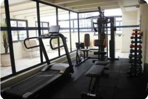 a gym with several tread machines and a window at Flat Transamerica4 bela cintra com estacionamento in Sao Paulo