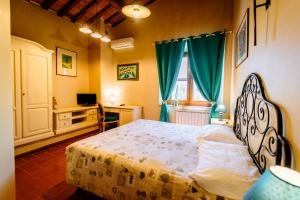 a bedroom with a bed and a desk and a window at Bio Agriturismo Il Melograno di Banditella Ristorante in Alberese +83 photos